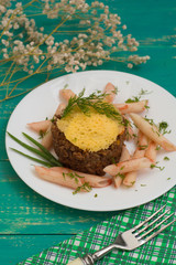 Meat casserole, Italian pasta and cheese crisps. Wooden background. Close-up