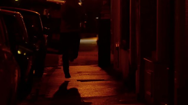 thief running away after a theft in the night, afraid to be caught