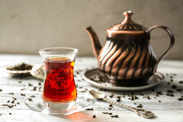 Turkish tea in traditional glass on wooden table closeup