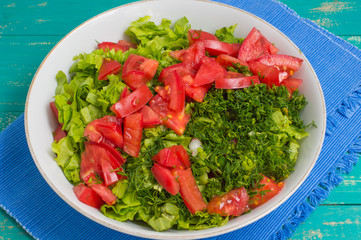 Summer vegetable salad on a wooden turquoise background. Close-up