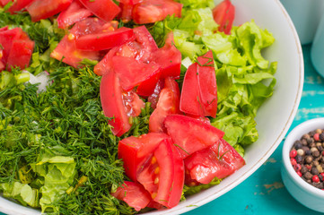 Summer vegetable salad on a wooden turquoise background. Close-up