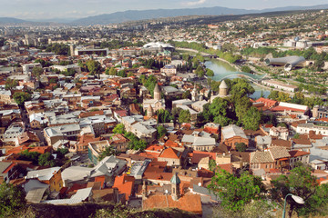 Fototapeta na wymiar Cityscape of historical center of Tbilisi with medieval churches and river Kura, Georgia country