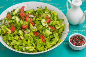 Summer vegetable salad on a wooden turquoise background. Close-up