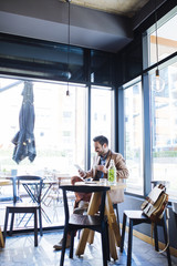 Fototapeta na wymiar Man Sitting in Coffee Shop