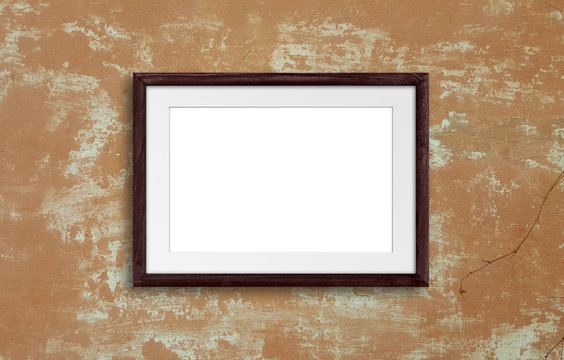 Brown natural wooden photo frame on old plastered wall, retro style, rustic interior decor mock up