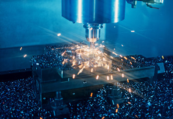 Milling machine working on steel detail with lot of sparks