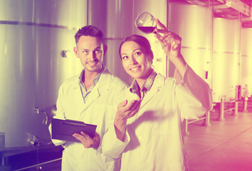 Young two experts examining wine