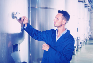 Portrait of  man wearing coat taking off data from equipment