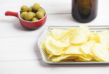Container with potatoes, beer and olives