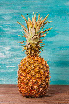 Pineapple is on the table a blue wooden background