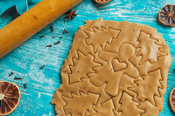 Gingerbread dough with molds for baking cinnamon on blue wooden table
