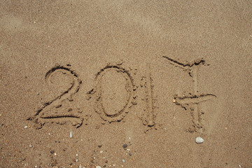 Numbers 2017 on beach. New year holiday concept .