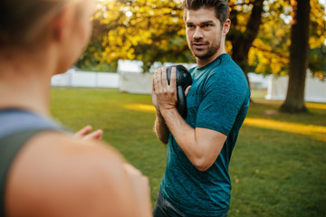 Fit young man exercising with kettlebell