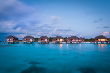 Maldivian water bungalows at dusk
