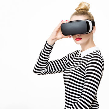 Fototapeta Attractive woman wearing virtual reality glasses. VR headset. Virtual reality concept on white background.