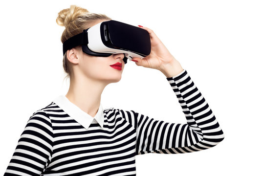 Fototapeta Attractive woman wearing virtual reality glasses. VR headset. Virtual reality concept on white background.