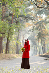 Beautiful young girl walking in autumn park.