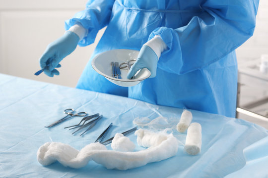Surgeon with tools on table