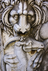 Ancient Roman sarcophagus with a relief depicting a lion tearing a goat