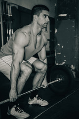 Fototapeta na wymiar Weightlifting training. Male lifting weights