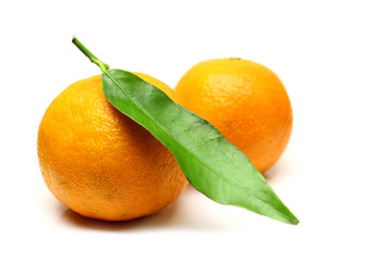Mandarin, tangerine citrus fruit, with green leaf, isolated on white background.