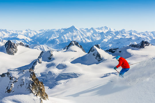 Skier skiing downhill Valle Blanche in french Alps in fresh powd