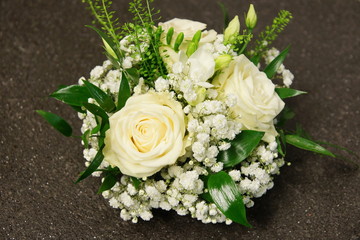 Flowers decoration with white roses and gypsophila on gray background 