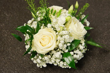 Flowers decoration with white roses and gypsophila on gray background 