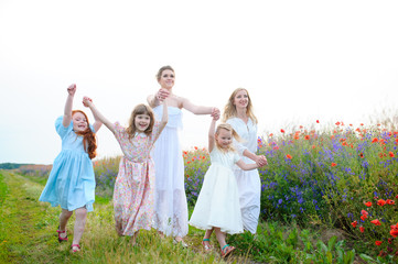 Naklejka premium Three happy children running on the field at the day time. Conce