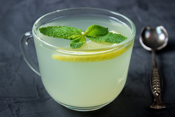 Closeup of Cup of Ginger tea with lemon and mint
