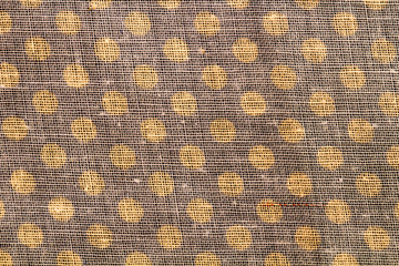 The texture of the fabric with gold circles. Close up macro. Abstract background.