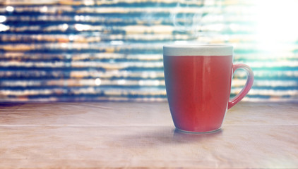 Red cup of coffee on old paper