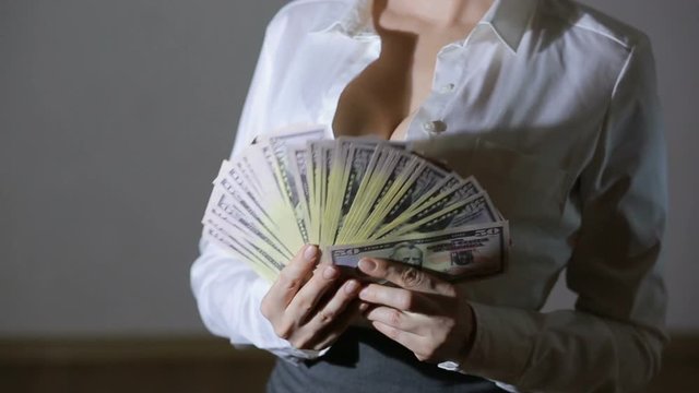 Beautiful young slim girl considers money