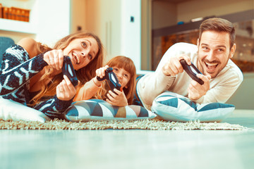 Happy family playing a video game at home