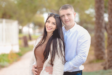 Fototapeta premium Portrait of beautiful young couple in love, background outdoor
