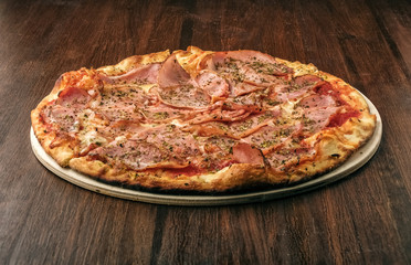 Delicious pizza prosciutto with ham and mozzarella