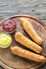 Stack of corn dogs on the wooden board