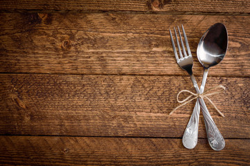 cutlery fork and spoon on a wooden background