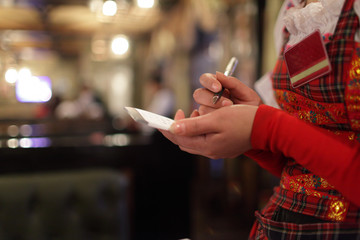 Waitress writing order