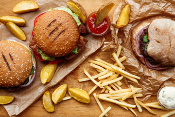 Fototapeta premium Fast food take away top view. Hamburger, hotdog and fries