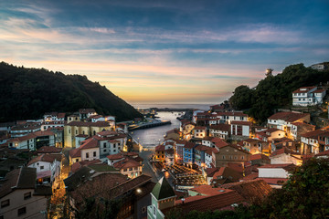 Beautiful view of coastal Asturias sea village Cudillero.in Spain, Europe during sunset or dusk. Gorgeous panorama of nature traditional famous touristic summer destination at dusk or dawn.