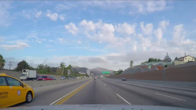 Timelapse hyperlapse of a car driving on a freeway road between mountains, on interstate 5 and route 14 , outside Los Angeles, California, in United states of America