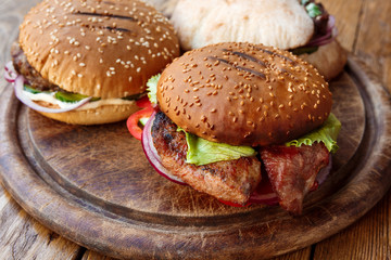 Classic american burgers, fast food on wood background
