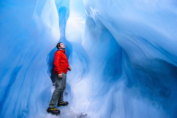 Man standing in an ice cave, Fox Glacier, Westland Tai Poutini National Park, South Island, New Zealand