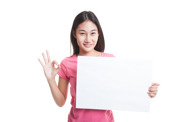 Fototapeta premium Young Asian woman show OK with white blank sign.