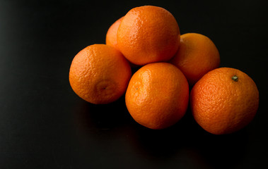 Pile of Six Clementine Oranges, From Side