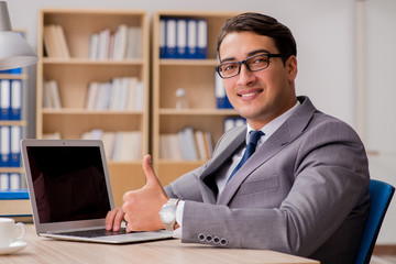 Young handsome businessman working on office
