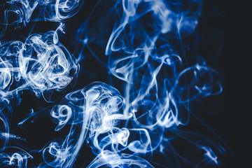 Naklejka premium Smoke swirling isolated on black background.