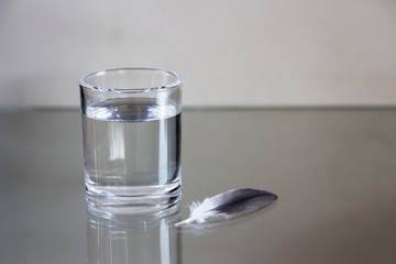 Drinking water in the glass and feathers.