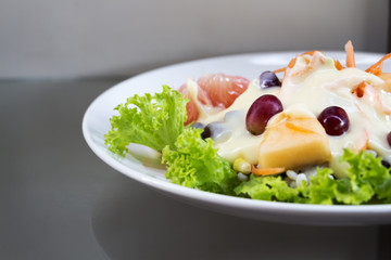 Fruit salad in a white dish.